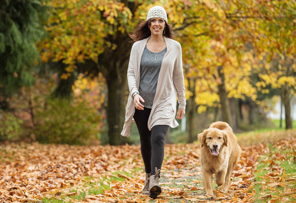 Picture of Woman Walking Golden Retriever | Dog Pictures Photography
